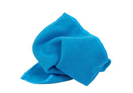 Horizontal shot of a crumpled blue washcloth on a white background.の写真素材