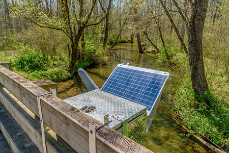Solar Energy Panel powers a Smoky Mountain research station set up next to a stream going through...
