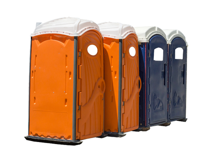 Horizontal Shot of Four Bright Colored Portable Potties.  Two are orange and two are dark blue.  Isolated on white.の写真素材