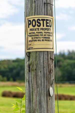 Vertical close-up shot of a No Trespassing Sign On a Telephone Pole.の写真素材