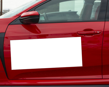 Horizontal shot of a blank white magnetic sign on a red carâ€™s driver side door.