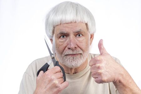 Horizontal shot of a gray haired man whoâs been in quarantine too long finally approves the haircut he gave himself with a thumbs up.の写真素材