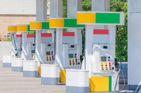 Horizontal shot of a row of fuel pumps with branding removed and colors changed.の写真素材