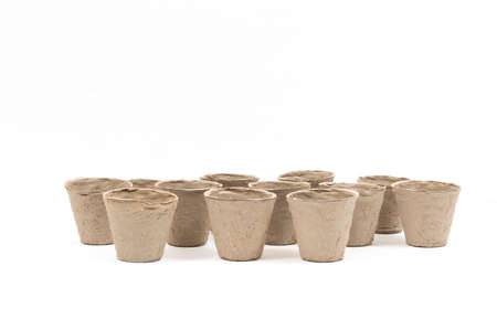 Horizontal shot of group of biodegradable peat pots for planting on a white background.  Lots of...