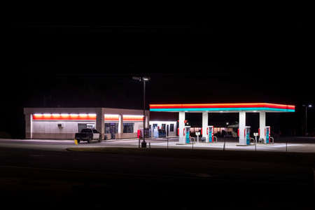 Horizontal shot of a small unbranded rural gas station with copy space top and bottom.