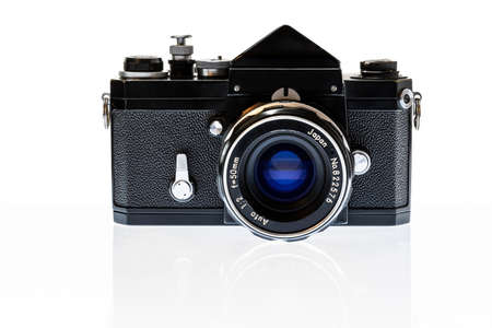 Horizontal shot of a professional 35mm SLR film camera from the 1960â€™s with reflection...