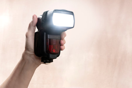 Horizontal shot of a hand held radio-controlled electronic flash with copy space.の写真素材