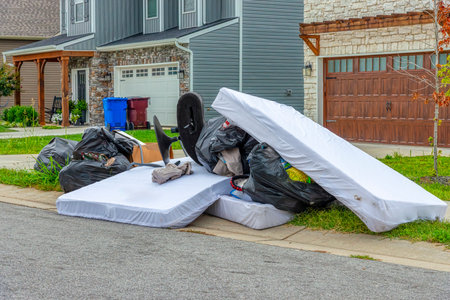 Horizontal shot of a large pile of curbside garbage awaiting pickup.の写真素材