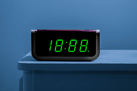 Horizontal close-up shot of a digital alarm clock you can change the time on with copy space.