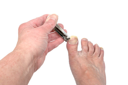 Horizontal shot of an old man trimming his toenail.の写真素材