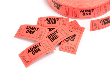 Horizontal close-up shot of a roll of red admit one tickets on a white background with copy space.の写真素材