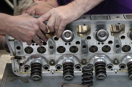 Skilled race car engine maintenance.