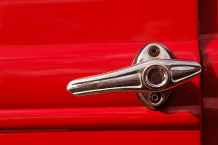 door lever from a red vintage automobileの写真素材