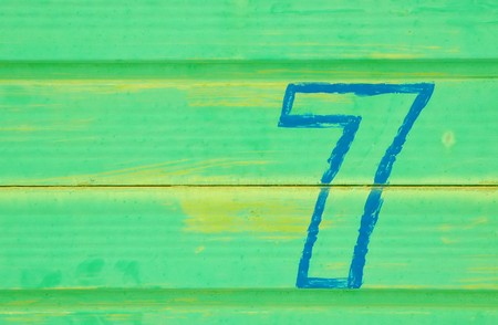 number 7 painted on a battered metal doorの写真素材