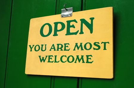 polite old welcome sign hanging in a doorwayの写真素材