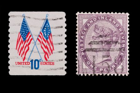 vintage U.S and Victorian stamps on blackのeditorial素材