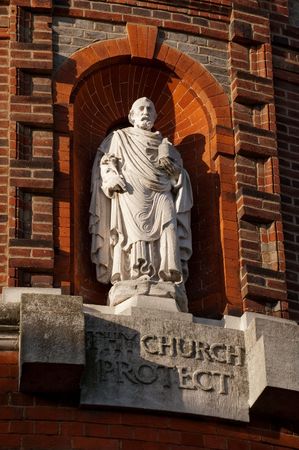 religious statue surrounded by ornate red brickworkの写真素材