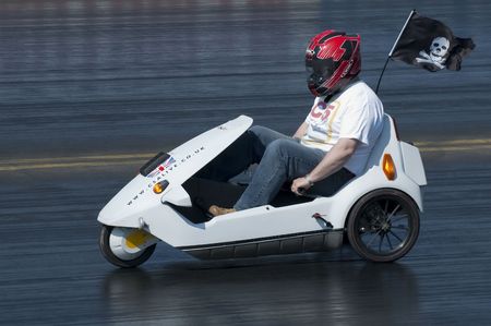 SANTA POD, UK - APRIL 23: Green energy drag racing at Santa Pod Raceway. Sinclair C5 electric vehicle on the quarter mile strip reaching 30mph, April 23, 2010, Santa Pod, UK.のeditorial素材