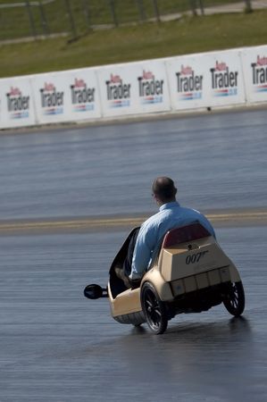 SANTA POD, UK - APRIL 23: Green energy drag racing at Santa Pod Raceway. Sinclair C5 electric vehicle on the quarter mile strip reaching 30mph, April 23, 2010, Santa Pod, UK.のeditorial素材