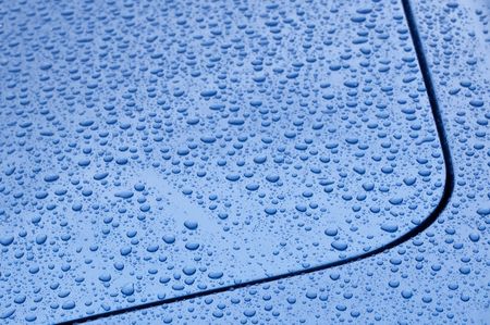 raindrop covered blue vehicle panel abstractの写真素材