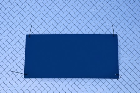 blank sign for copy tied to a wire fenceの写真素材