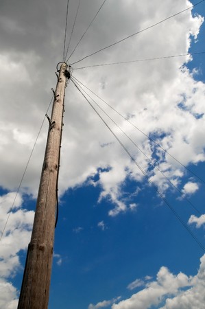 utility pole and wires under a cloudy skyの写真素材