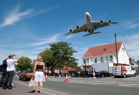  Farnborough International Airshow, UK - July 19, 2010: Massive Airbus A380 aircraft on landing approach over a local suburban street. のeditorial素材