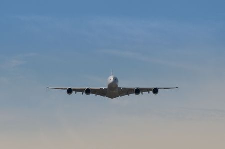 Farnborough International Airshow, UK - July 19, 2010: Airbus A380 level flight head-on through hazy sunshine.のeditorial素材