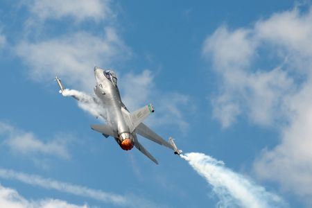 FARNBOROUGH AIRSHOW, UK - JULY 24, 2010: USAF F-16 in a steep climb using reheat. 