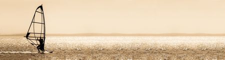 sepia toned windsurfer panorama silhouetteの写真素材