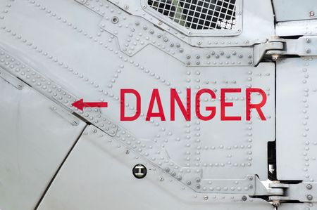 danger sign on the side of a riveted aircraft fuselageの写真素材