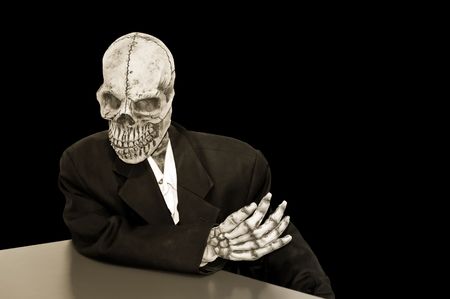 creepy skeleton in a dusty suit on a black backgroundの写真素材