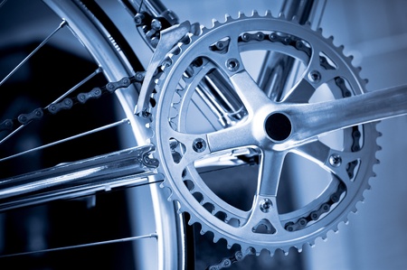 chromed precision racing bike gearwheels and chain with a blue tintの写真素材