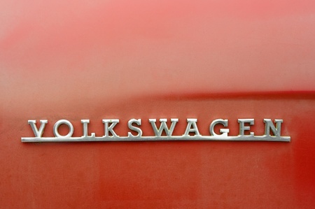 Volksworld Show, Sandown Park, UK - March 26, 2011: Rusting Volkswagen auto badge on the bodywork of...