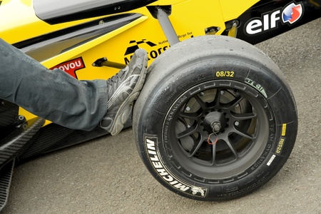 Thruxton, United Kingdom - May 1, 2011: Mechanics foot helping to move a race car at the Formula Renault championship meeting in Thruxton, UKのeditorial素材