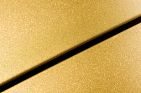 glittering golden vehicle panel closeupの写真素材