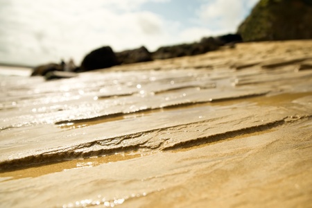 erosion of the tide on a sandy beach with shallow d.o.fの写真素材