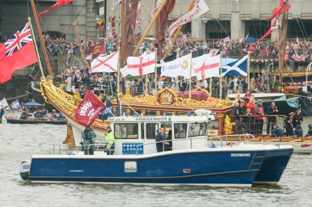 London, UK - June 3, 2012: Royal row-barge Gloriana and Thames Harbour Master tugboat, part of the one thousand vessel Queen Elizabeth II Diamond Jubilee Pageant on the River Thames.のeditorial素材