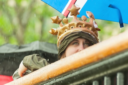 London, UK - June 3, 2012  Beautiful girl in the rain wearing a crown watching the Queen Elizabeth II Diamond Jubilee Pageant on the River Thames のeditorial素材