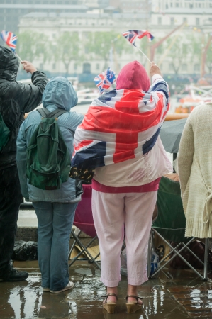 british people in heavy rain celebrating a paradeの写真素材