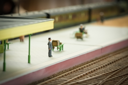 miniature model of a well dressed man waiting for a trainの写真素材