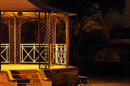 empty bandstand stage under faint spotlightsの写真素材