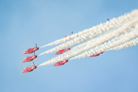 Farnborough, UK - July 18, 2014: The Red Arrows formation aerobatic display team leaving smoke trails in the sky over Farnborough, UKのeditorial素材