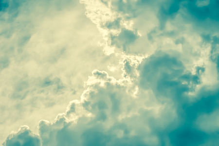 retro toned cloudscape background with blue and yellow tintの写真素材