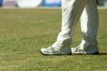 feet of a cricketer in traditional white trousersの写真素材
