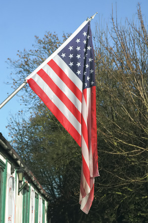 stars and stripes hanging outside a building