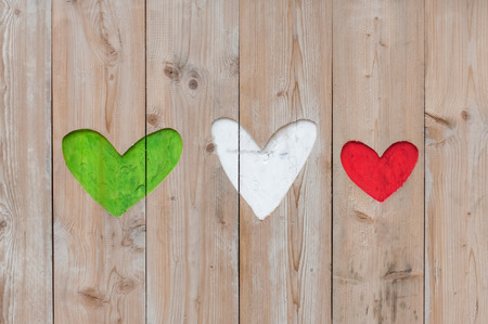Italian flag colors carved into wooden love heartsの写真素材