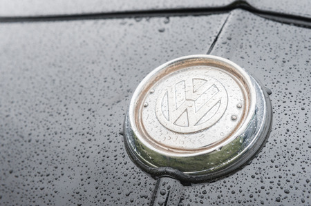 Rushmoor, UK - April 3, 2015: Closeup of a vintage VW vehicle badge insignia covered with raindrops.のeditorial素材