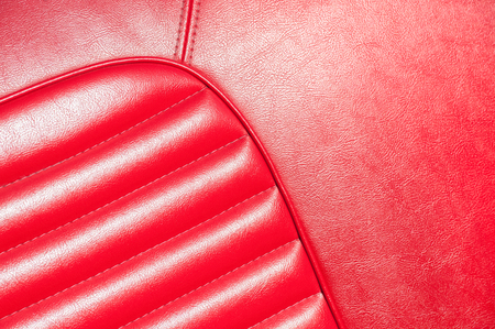 luxurious red leather classic car interior closeup in sunlightの写真素材