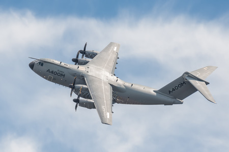 Farnborough, UK - July 16, 2016: Propeller vortex spinning over the wings of an Airbus A400M military transporter aircraft after take-off from Farnborough, Hampshire, UKのeditorial素材